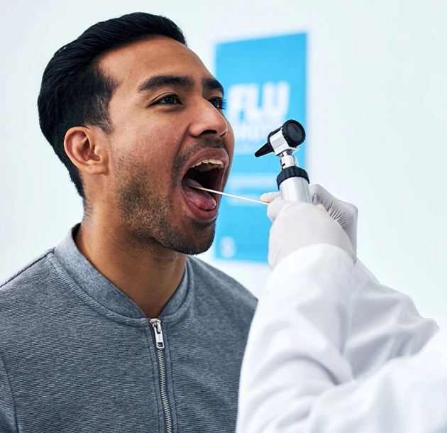 Man receiving dental examination with dentist holding mirror in modern clinic setting.
