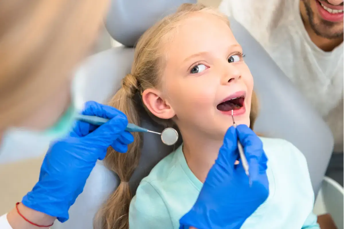 Young girl receiving dental sealant treatment from dentist in Silver Spring.