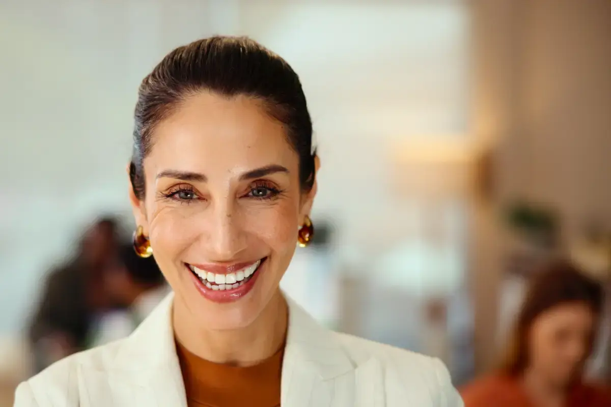 Smiling woman in professional attire at dental practice in Silver Spring, Maryland.